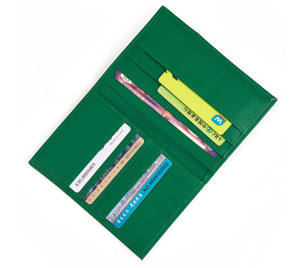green passport holder and travel wallet