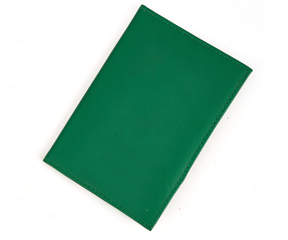 green passport holder and travel wallet