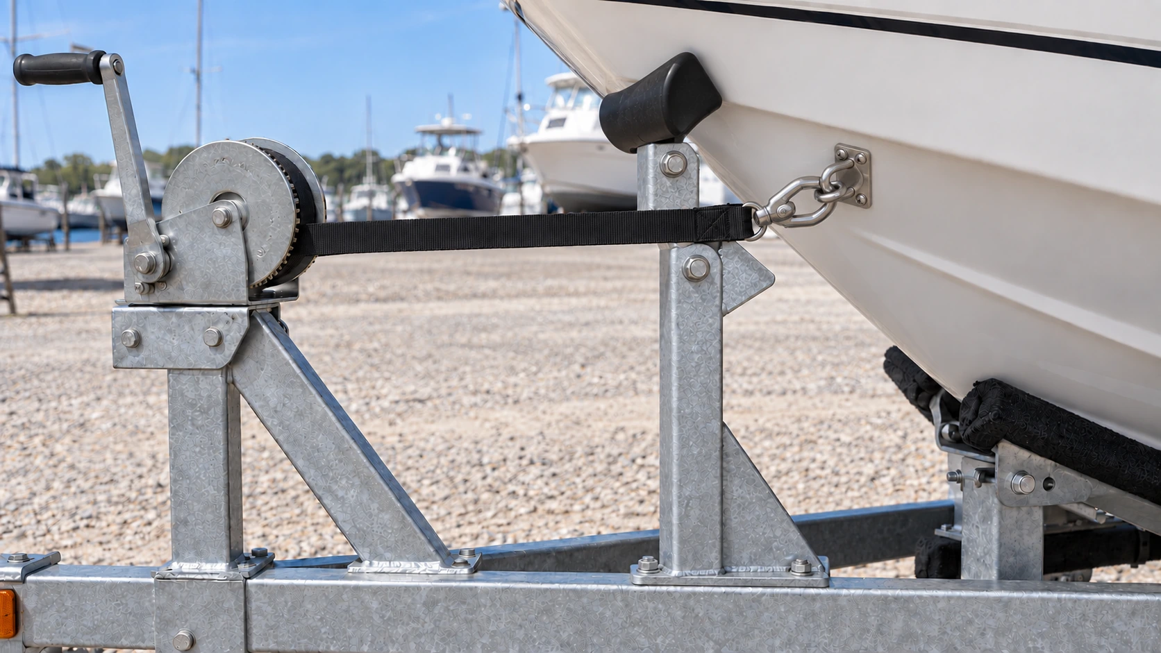 Boat bow seated at trailer bow stop with winch strap connected to bow eye