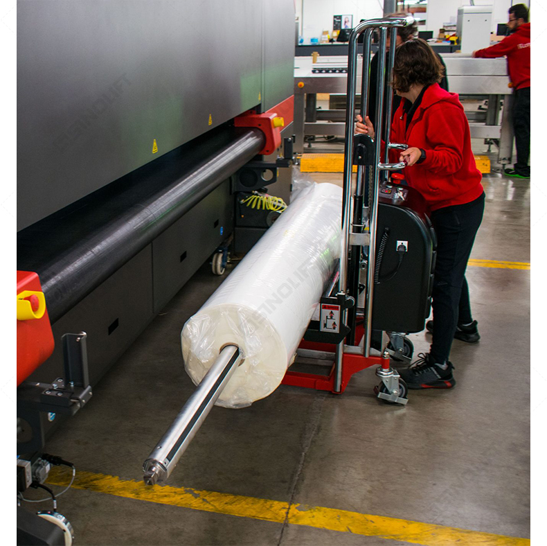 SINOLIFT EFM electric roll lifter in action with secure tilting mechanism, designed for precise loading and transporting of bulky cylindrical materials.