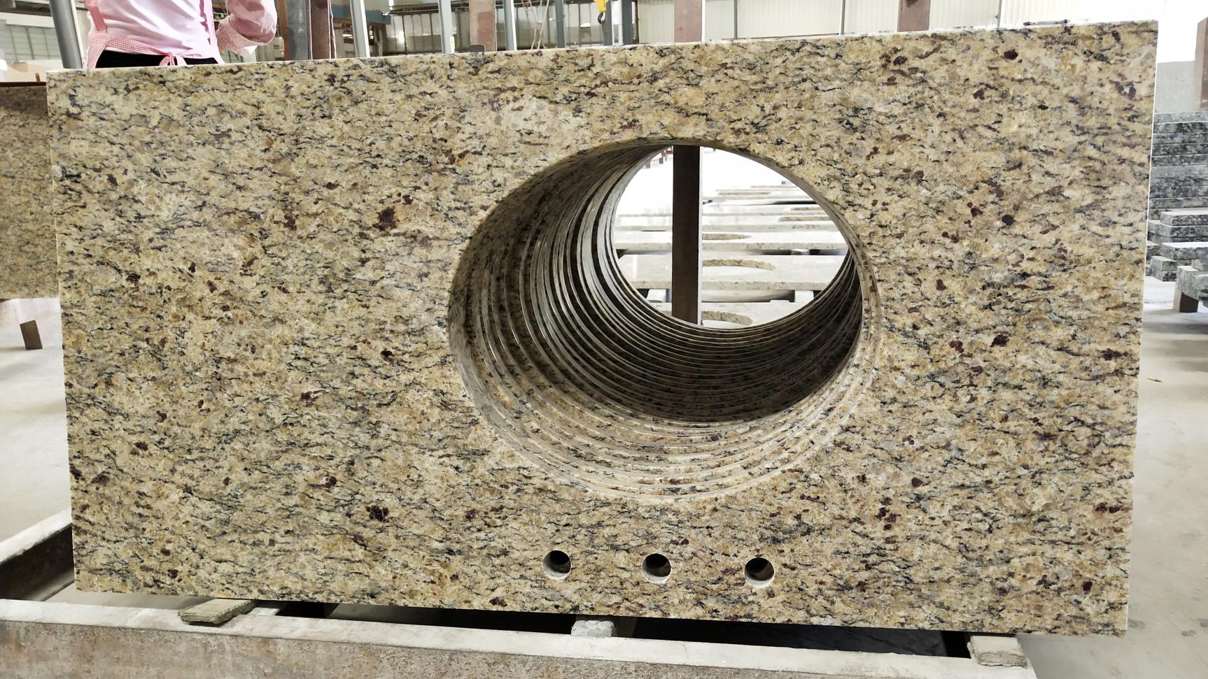 Ouro Brasil Granite Vanity Countertop uses a light honey-colored base with white, black and amber spots on the whole.