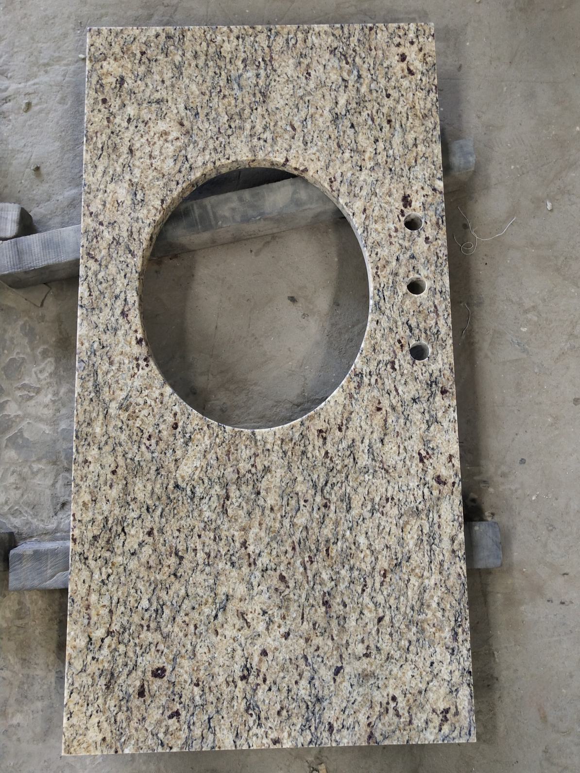 Ouro Brasil Granite Vanity Countertop uses a light honey-colored base with white, black and amber spots on the whole.