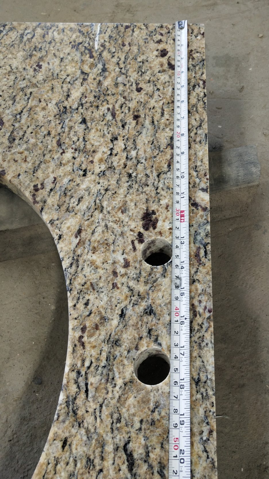 Ouro Brasil Granite Vanity Countertop uses a light honey-colored base with white, black and amber spots on the whole.