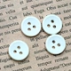 Chalk buttons, with their crisp white hue resembling chalk, offer a clean and polished look to garments.