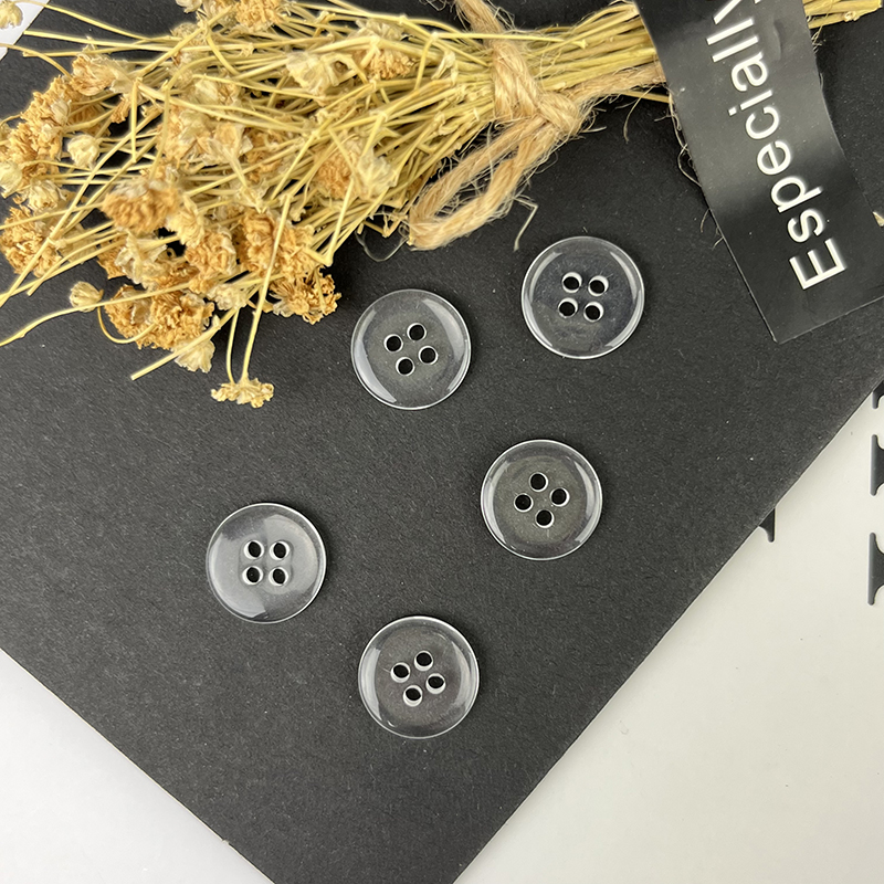Transparent buttons are made of unsaturated resin material and can add a modern and fashionable touch to clothing and accessories.