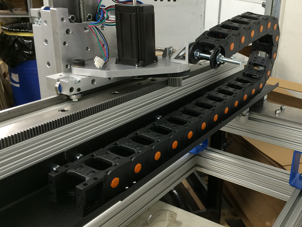 A flexible cable carrier system guiding and protecting industrial cables in automated machinery, designed for repetitive motion applications like assembly lines and robotic arms.