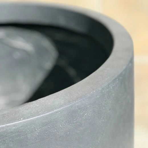 Close-up of a smooth GFRC planter rim with a subtle gray concrete finish