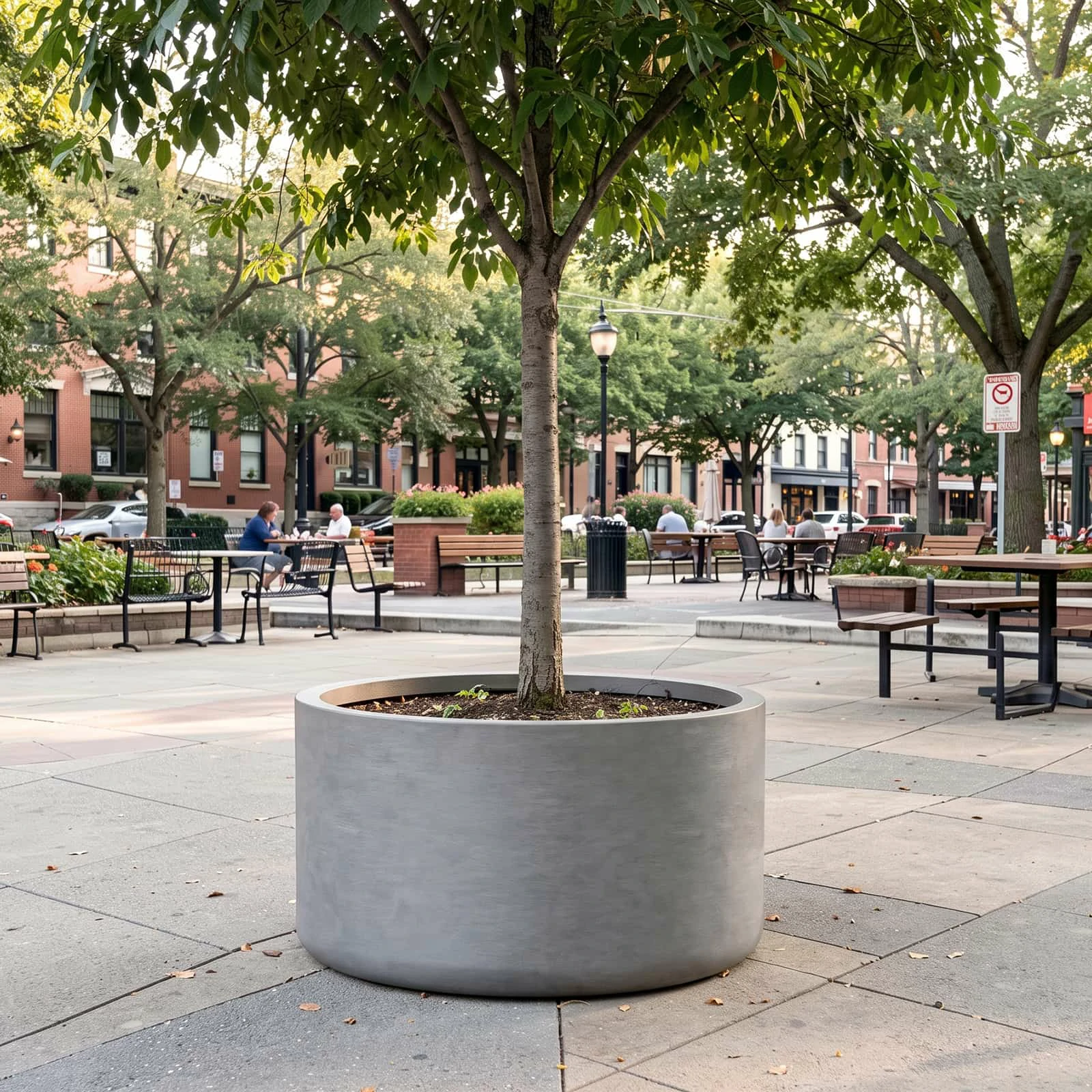RC-1066 oversized round GFRC planter installed in a public plaza landscape
