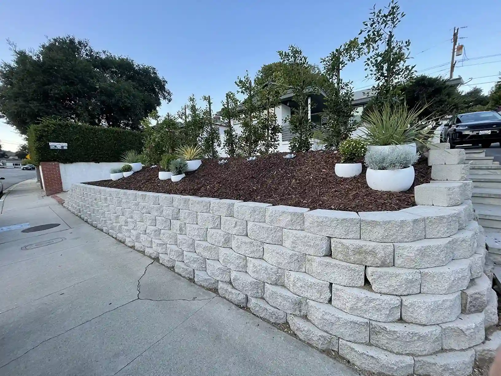 Durable GRC pots serving as permanent green infrastructure in a commercial plaza
