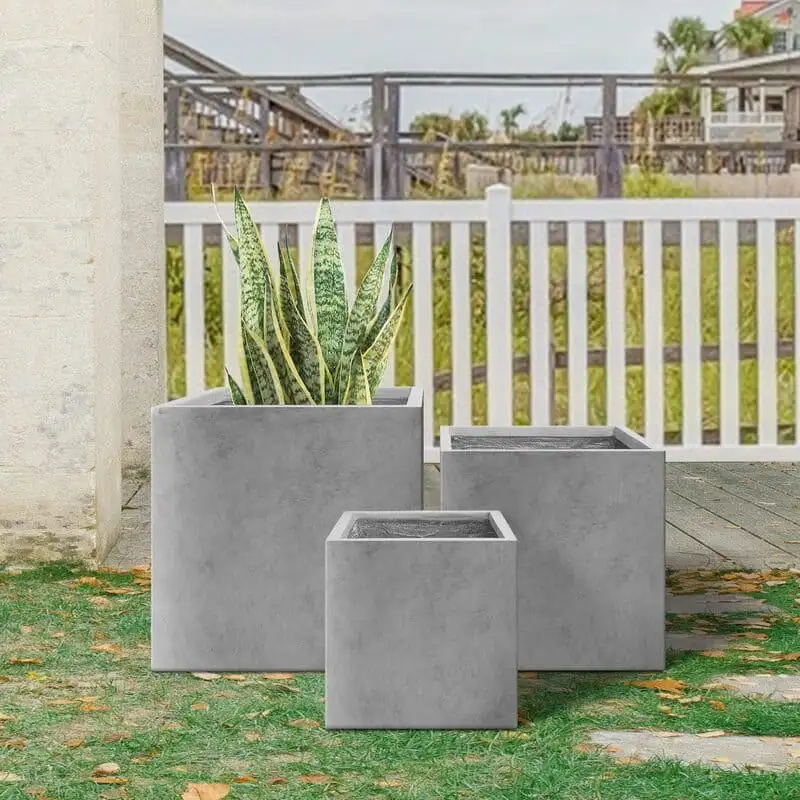 Three square outdoor concrete planters demonstrating coordinated sizes and proportions