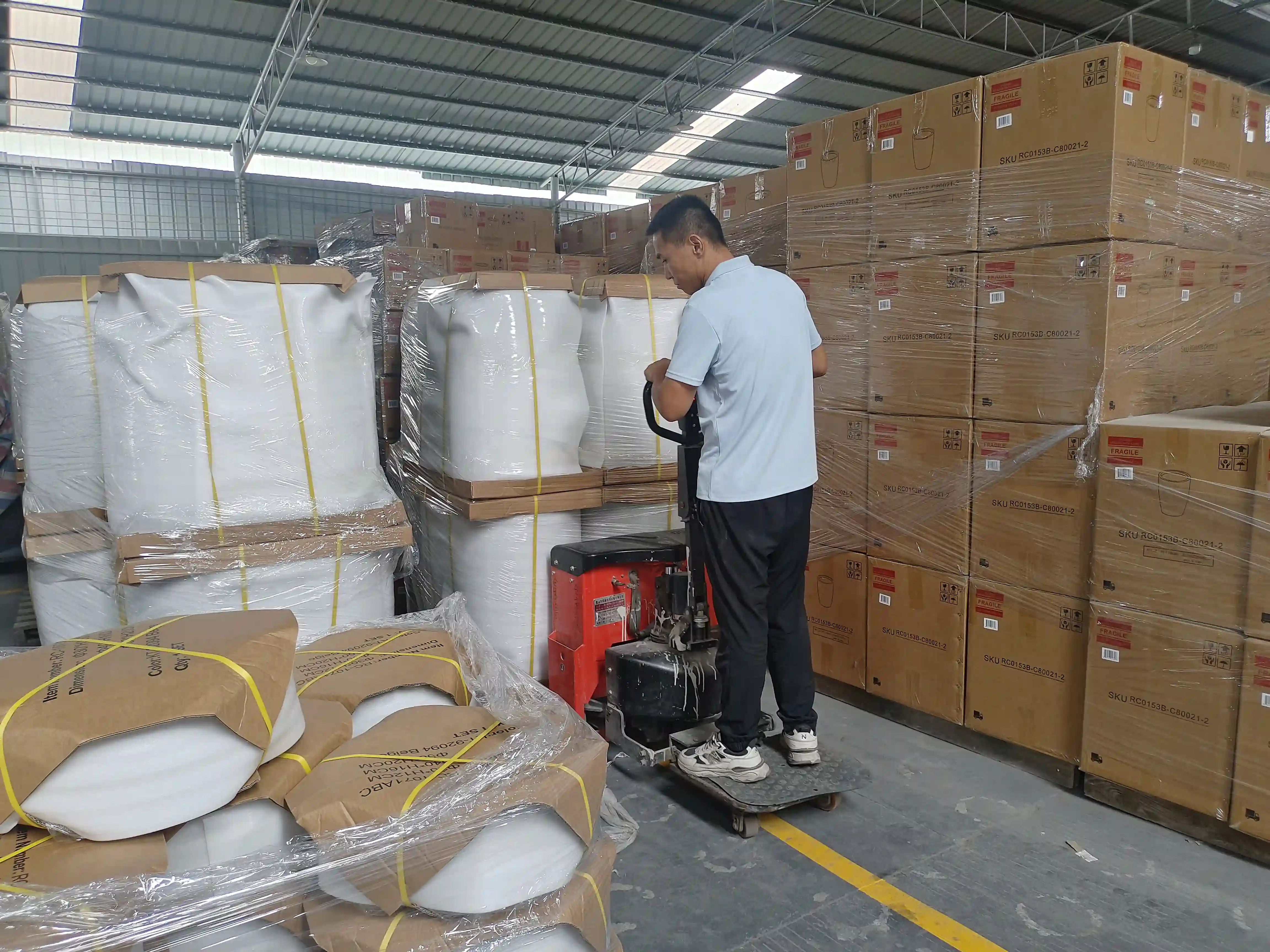 Large planters with protective packing being handled in the Ronglin warehouse