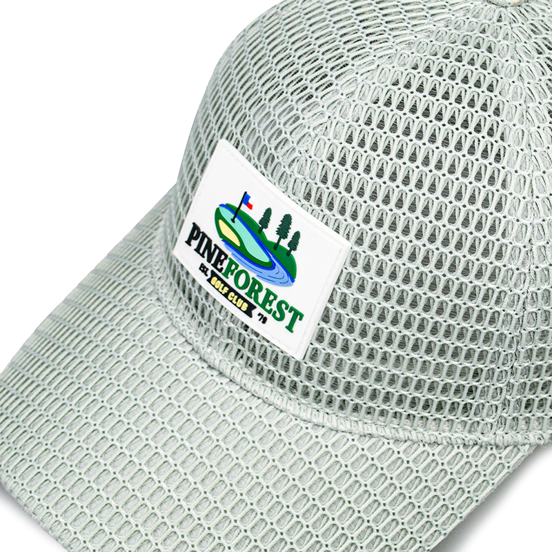 This cap is a stylish and functional accessory perfect for golf enthusiasts. Made with a breathable mesh fabric, it ensures excellent ventilation, keeping your head cool during outdoor activities. The front features a vibrant patch ，howcasing a picturesque golf course scene with a flag, trees, and a winding river, adding a touch of sporty charm. Its lightweight design and comfortable fit make it ideal for a day on the golf .