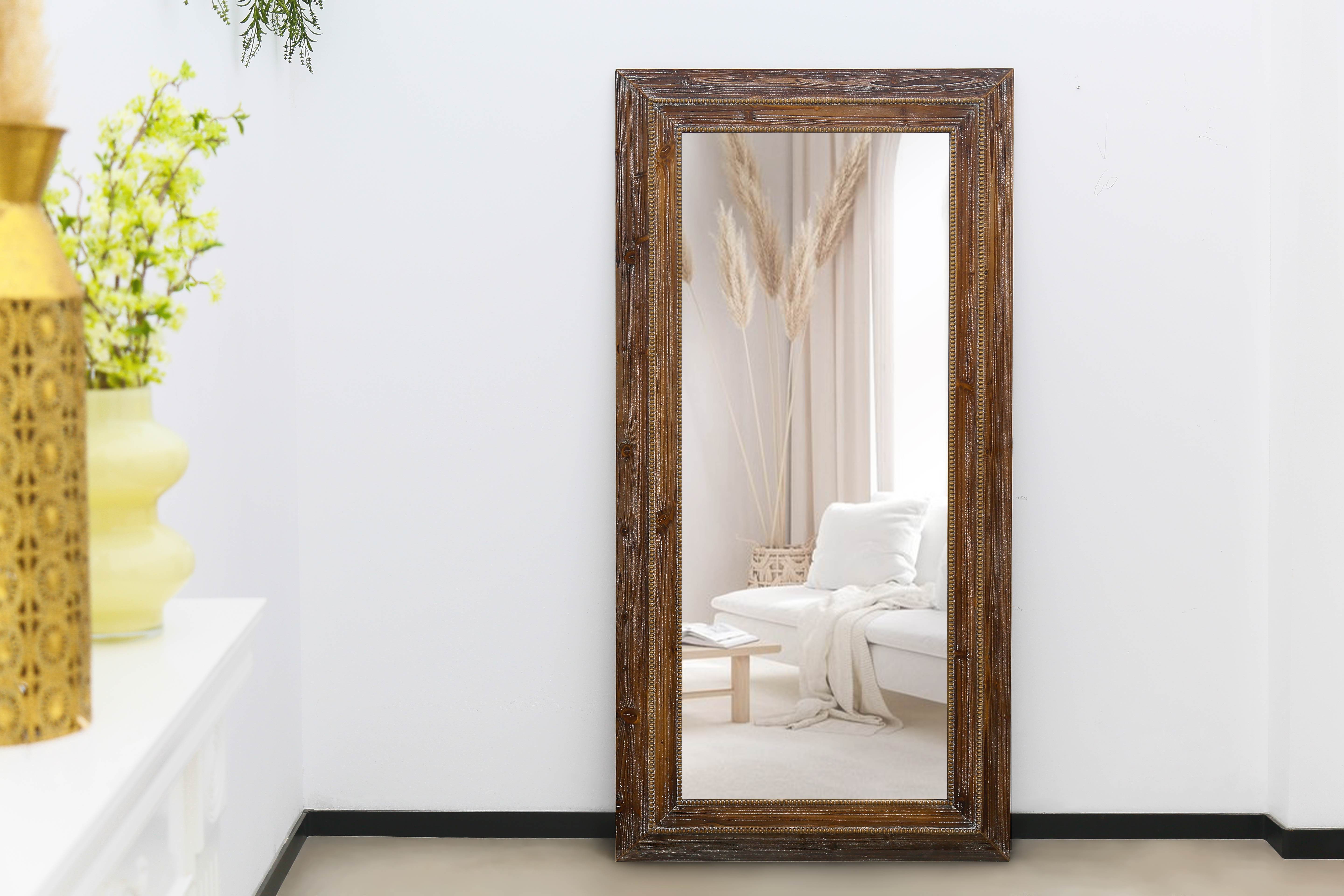 antique carved wood mirror in a lively living room with european decor