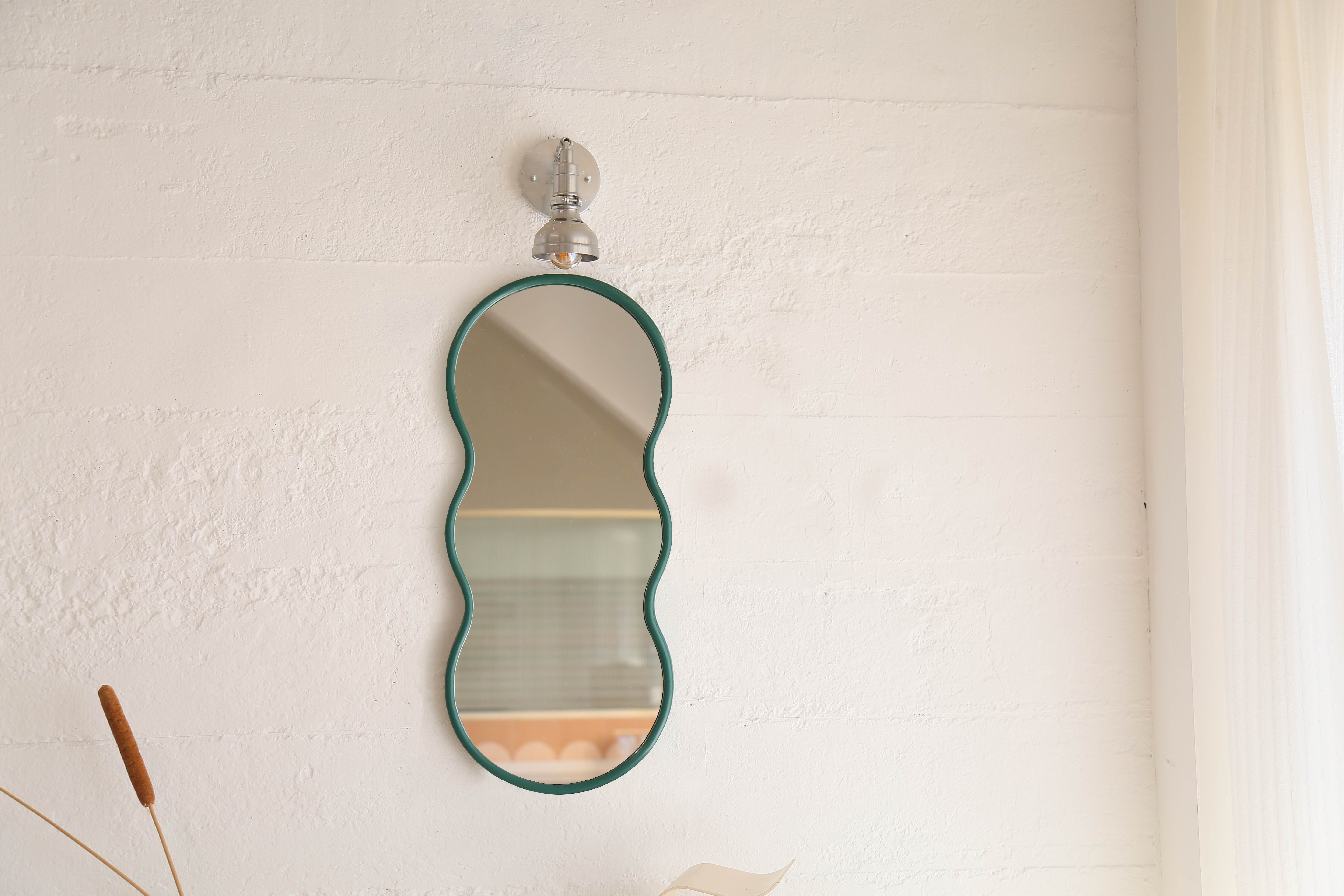 27-inch Teal Ripple Mirror brightening a minimalist living room