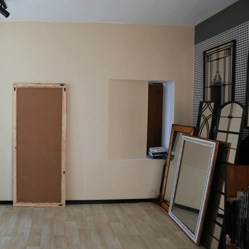 wooden frame mirror's back side against the wall