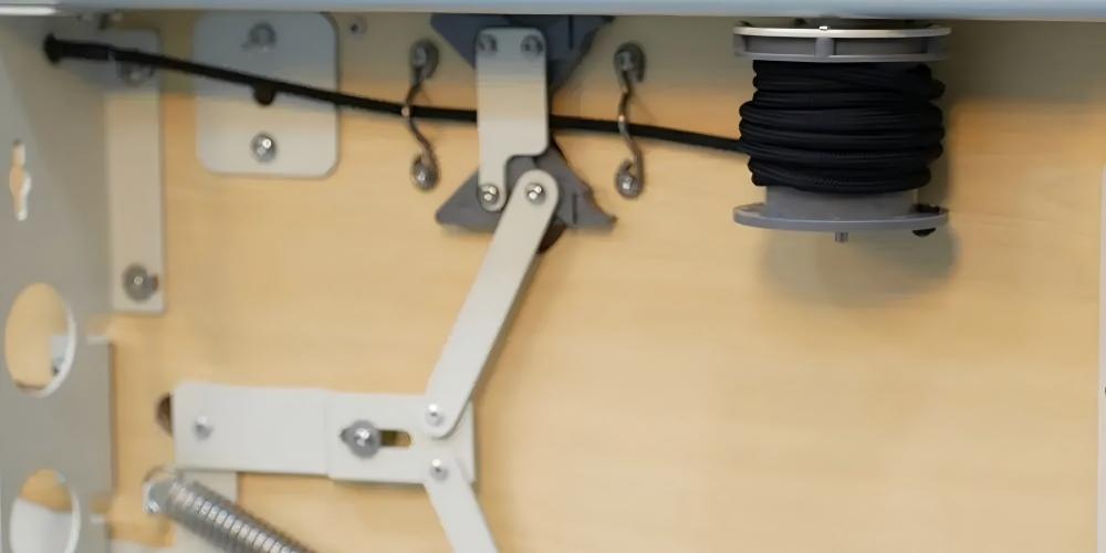 Hidden rope adjustment system behind shoulder rest