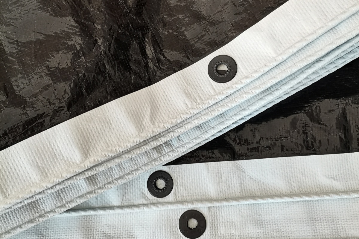 Black & White Poly Film – Close-Up of Plastic Grommets on Cherry Rain Shelter