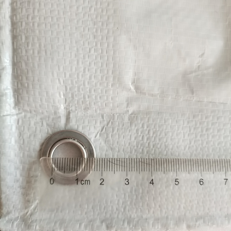 Black & White Poly Film – Close-Up of Aluminum Grommets on Cherry Rain Shelter