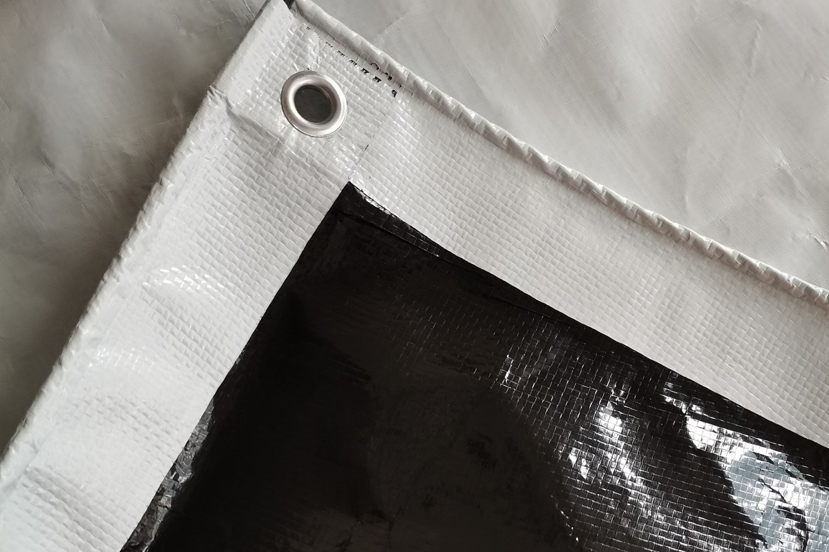 Black & White Poly Film – Aluminum Grommet Detail on Cherry Rain Shelter