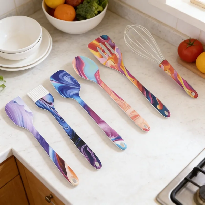 Set of 6 colorful marbled silicone kitchen utensils (spatula, basting brush, spoons, slotted turner, whisk) neatly arranged on a white marble kitchen countertop, with fresh produce and dishware in the background.