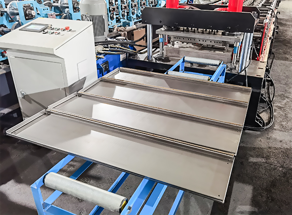 Finished steel shelf panels exiting the SUNWAY box plate roll forming machine onto the run-out table