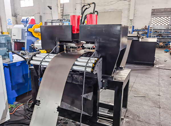 Hydraulic punching and notching station creating corner cuts on galvanized steel sheet