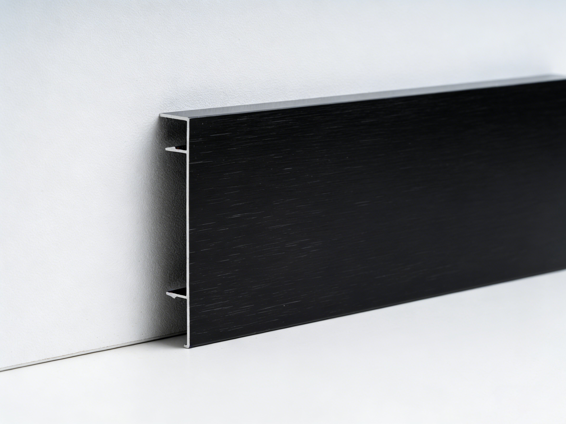 Close up of aluminum alloy skirting board profile showing durable metal wall base trim design