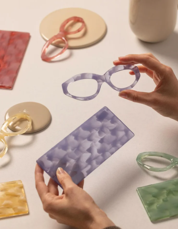 CNC machine cutting acetate eyewear frames in factory