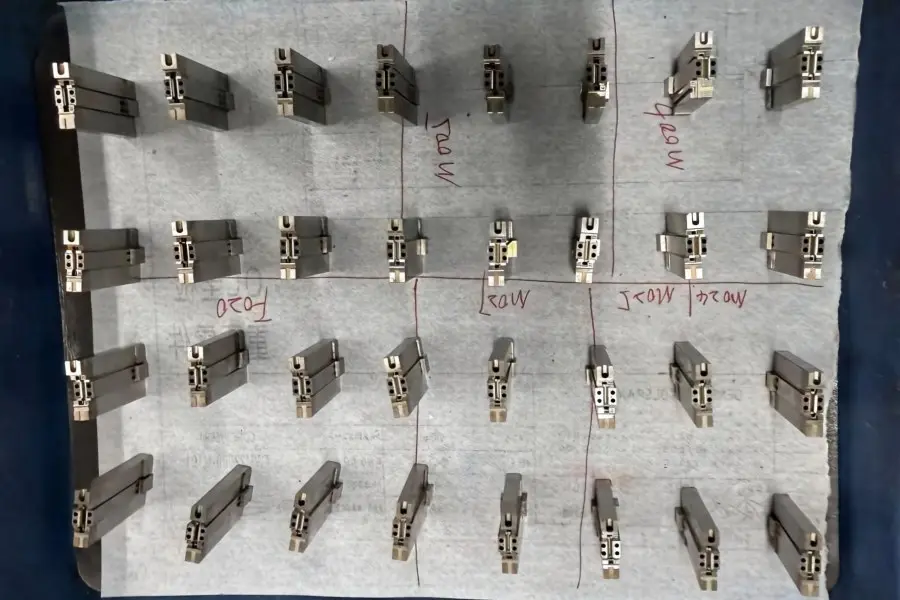 Mold Components Prepared for Assembly Machined mold components organized and prepared for assembly