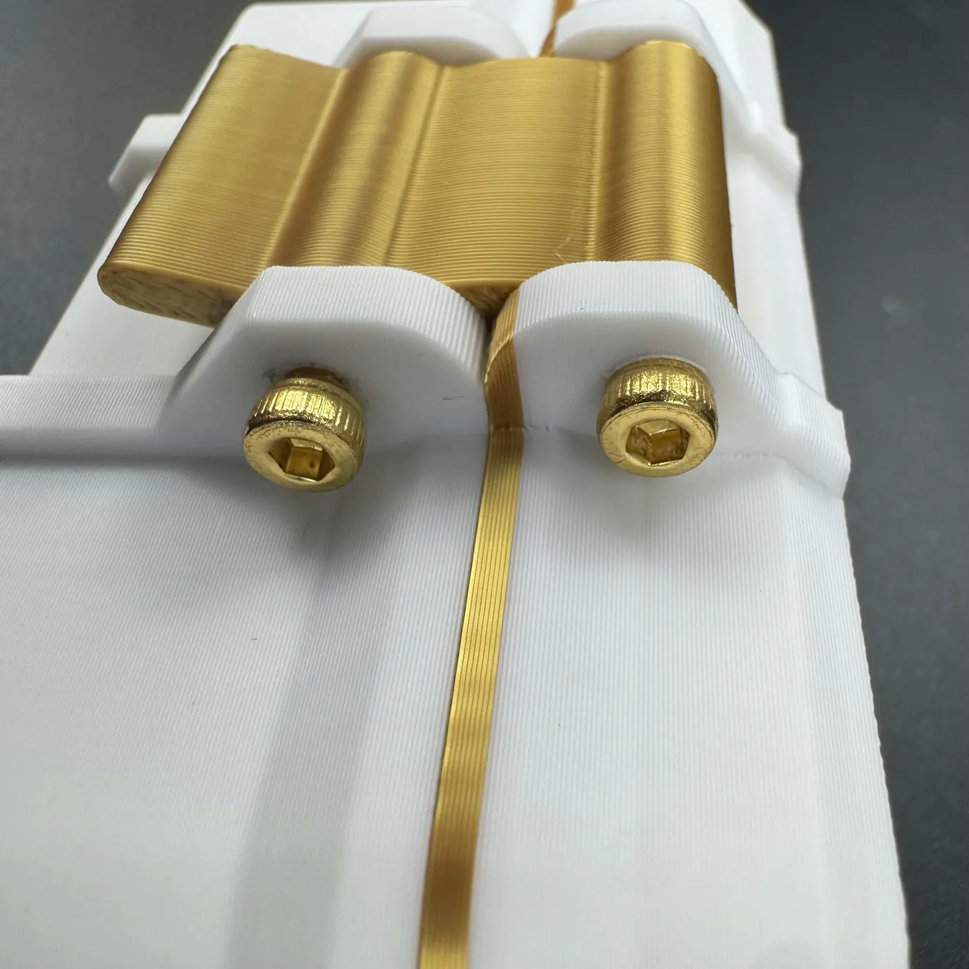 gold-finish hinge screws and pin detail on the white 4 slot linear 3ml vial case