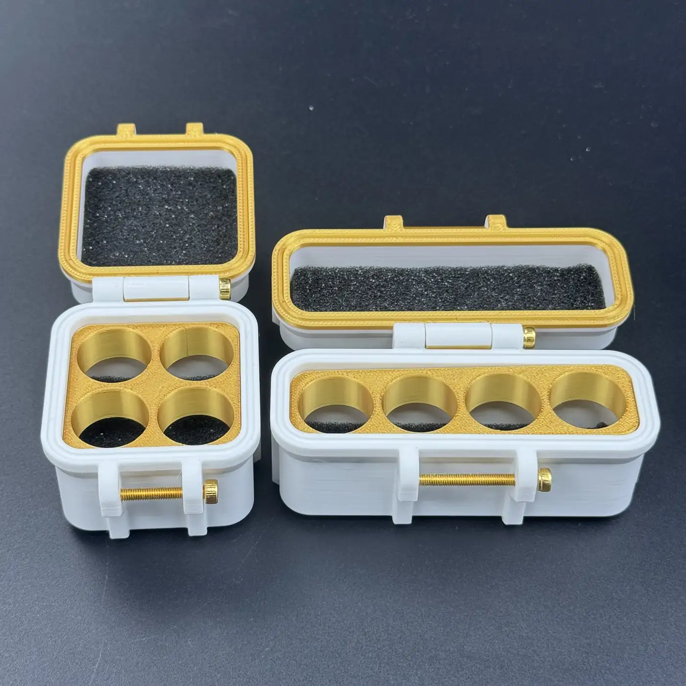 two white 3ml vial cases opened side by side revealing gold inserts