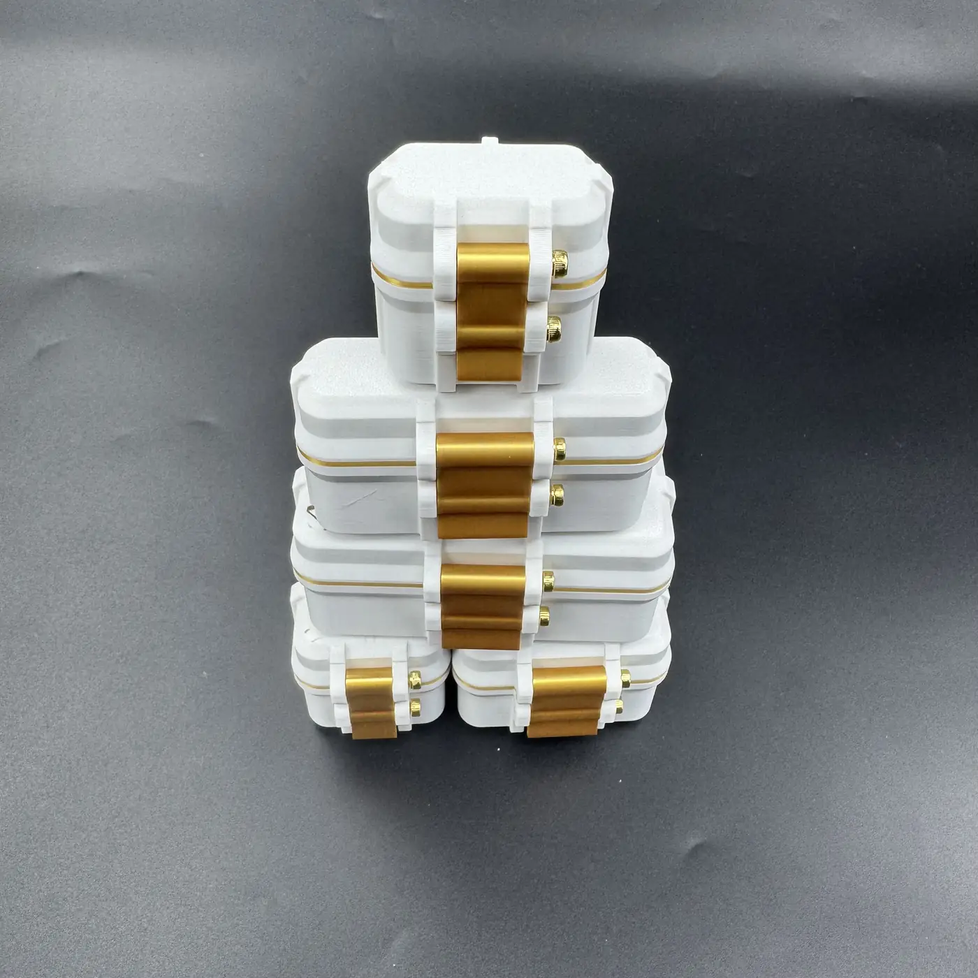 white and gold 3ml vial cases stacked together in one tower
