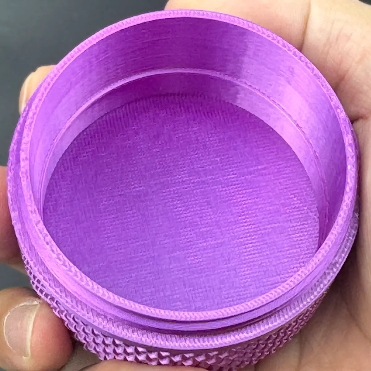 the printed tray lifted out of the cylindrical vial case, leaving an empty threaded shell