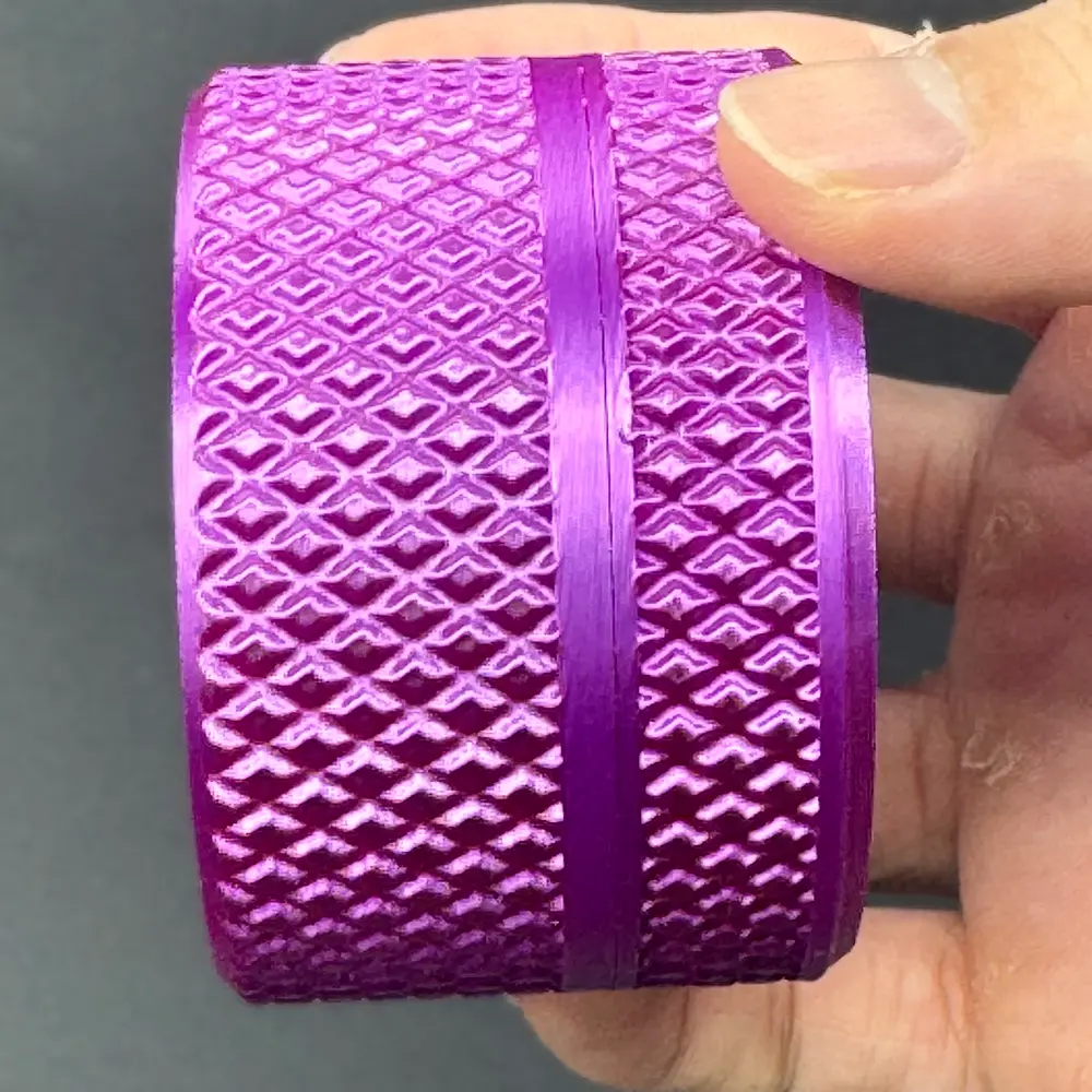 close-up of the knurled grip band and screw thread of the cylindrical vial case