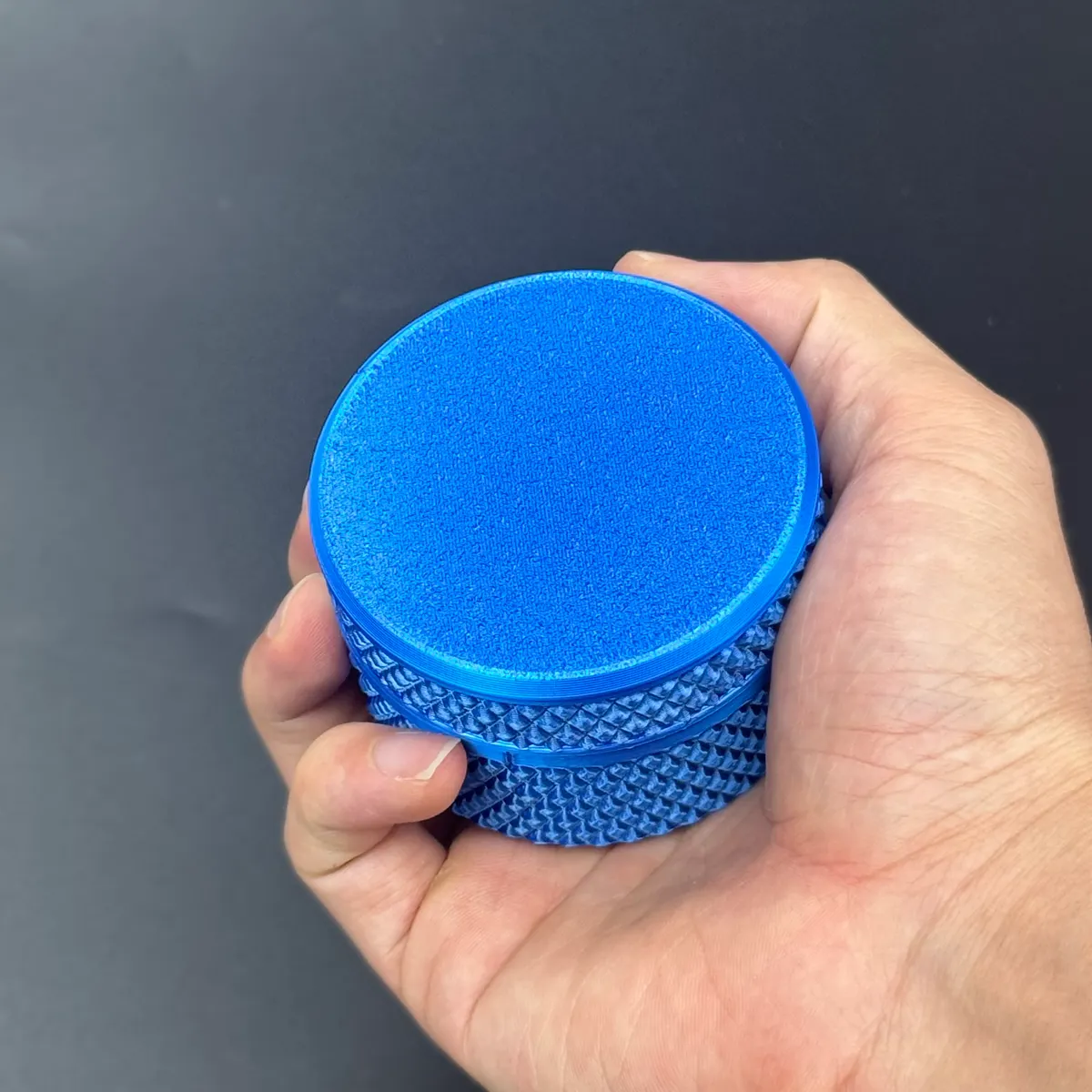 the 65 mm cylindrical 3ml vial case held in a palm for scale