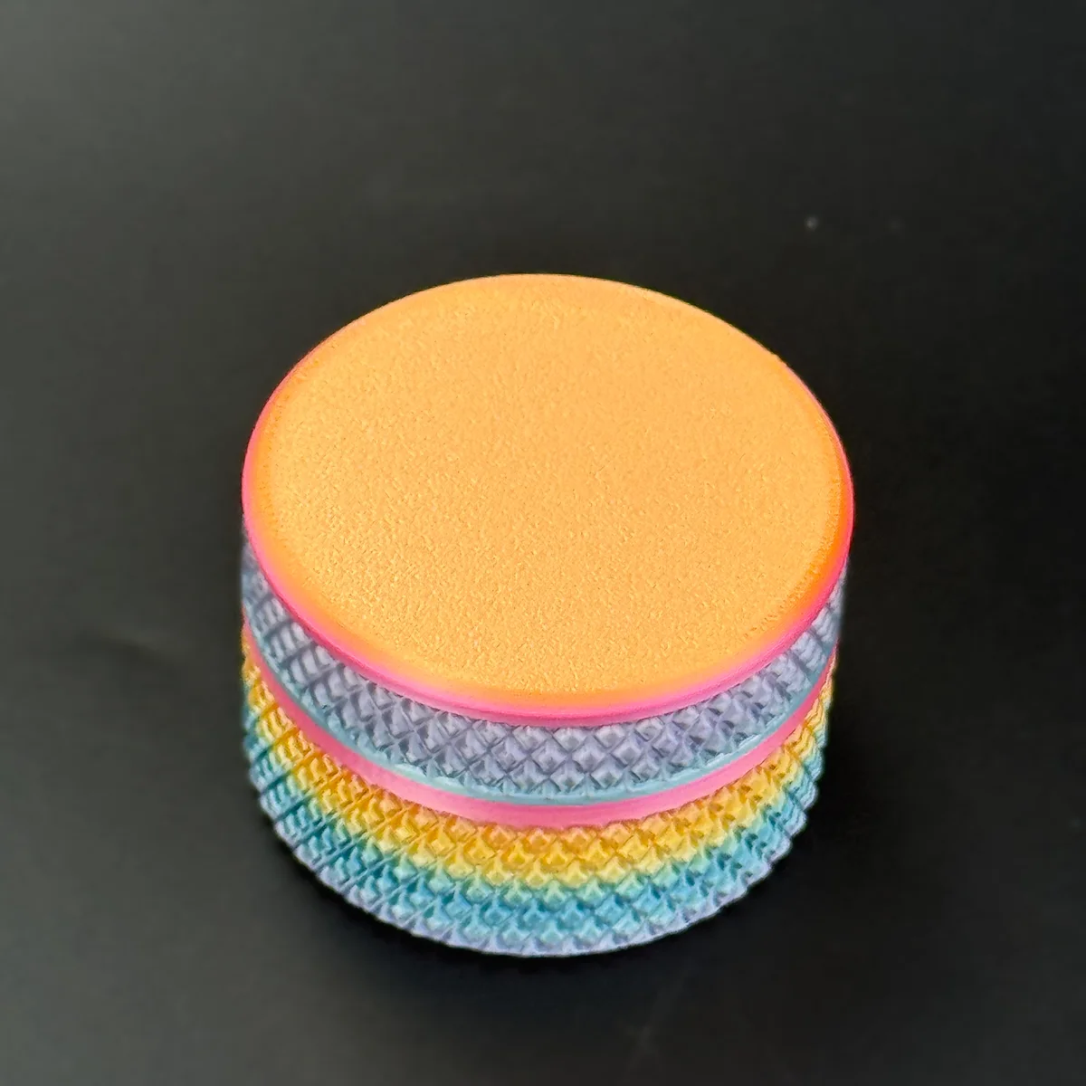 orange lid on a rainbow gradient shell, one assembled pairing
