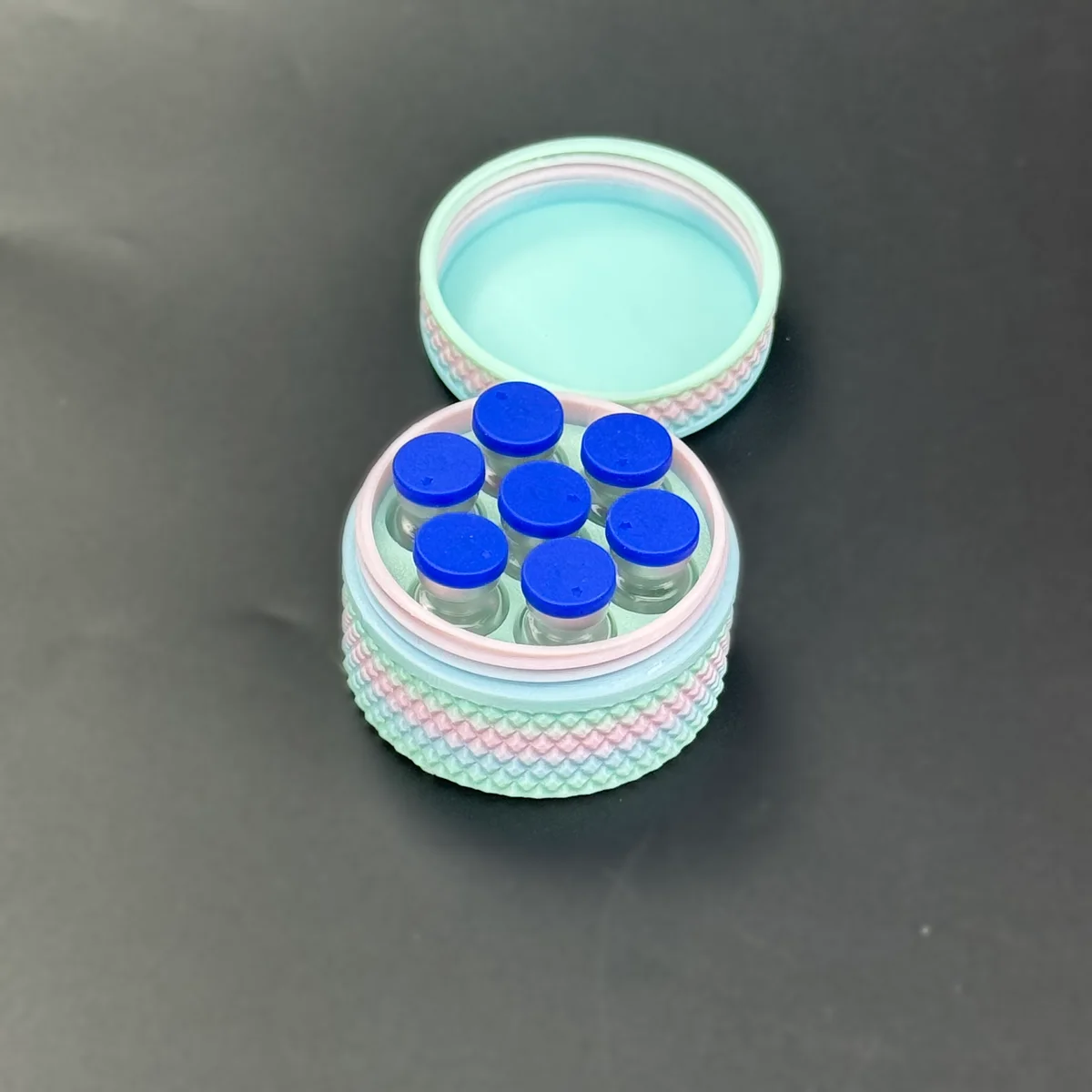 seven 3ml glass vials loaded in the honeycomb tray of the case