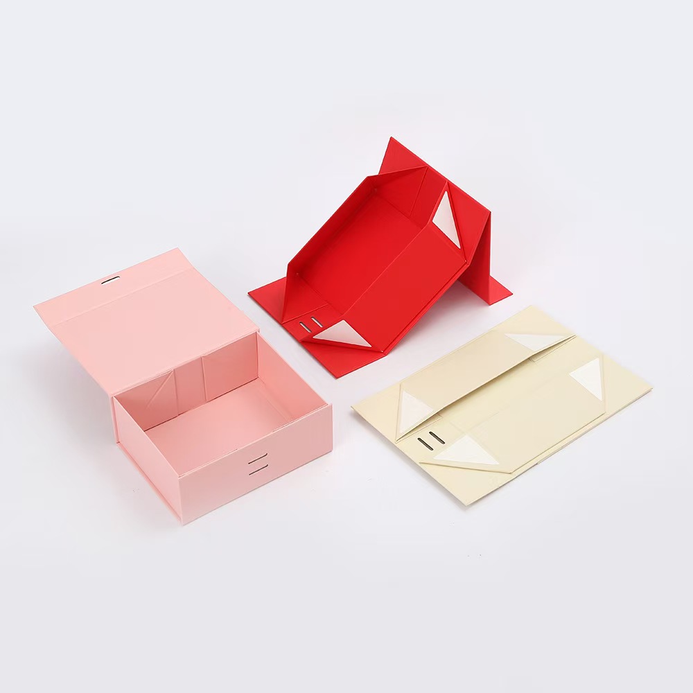 Origami-style fold paper gift boxes in multiple colors (pink, red, beige) — customizable small paper boxes for home use, featuring ribbon closure and elegant design