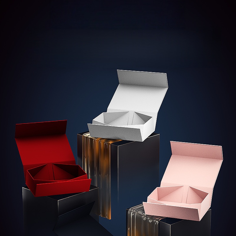 HC.PRINTERS gift box collection featuring open red, white, and pink boxes with internal compartments, displayed on black pedestals against a dark background.