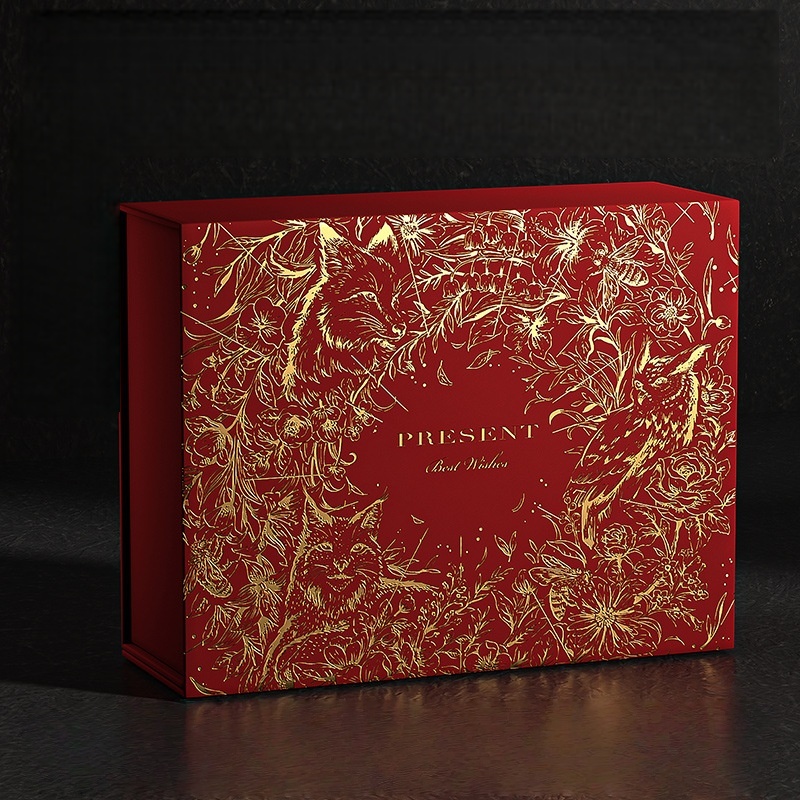 Luxurious red HC.PRINTERS gift box with intricate gold floral embossing and