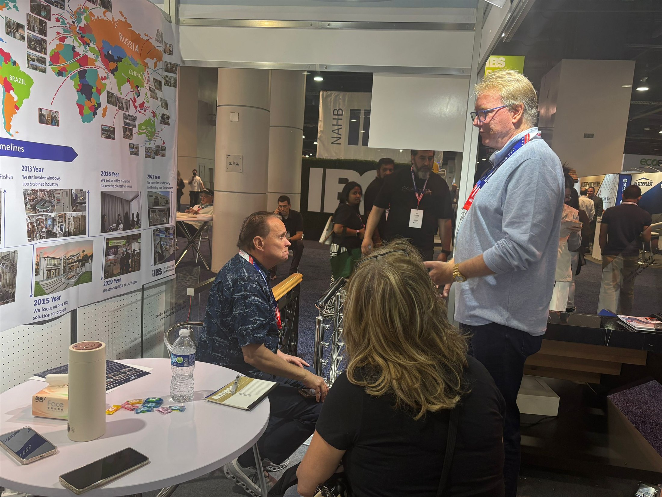 Staff and a visitor beside the timeline wall