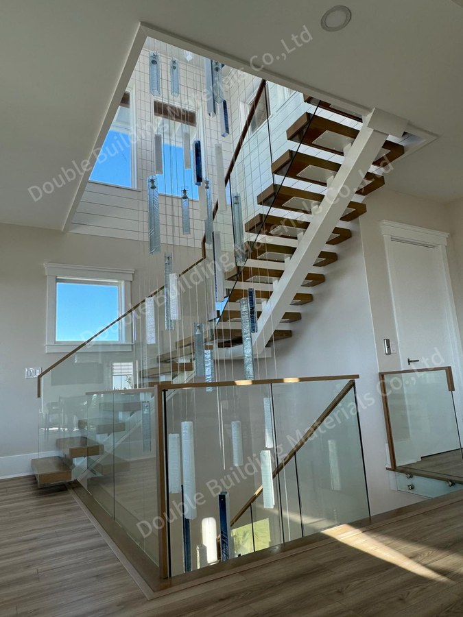 White square tube mono-stringer staircase with open wood treads and glass balustrade in Virginia