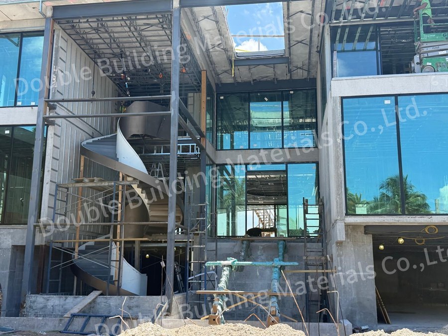 Install view of dual tone stringers for two stacked curved staircase flights in an unfinished shell