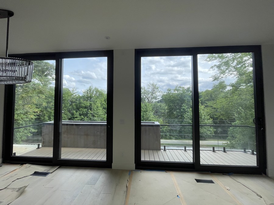 Black standoff pins on stair tread with glass panel