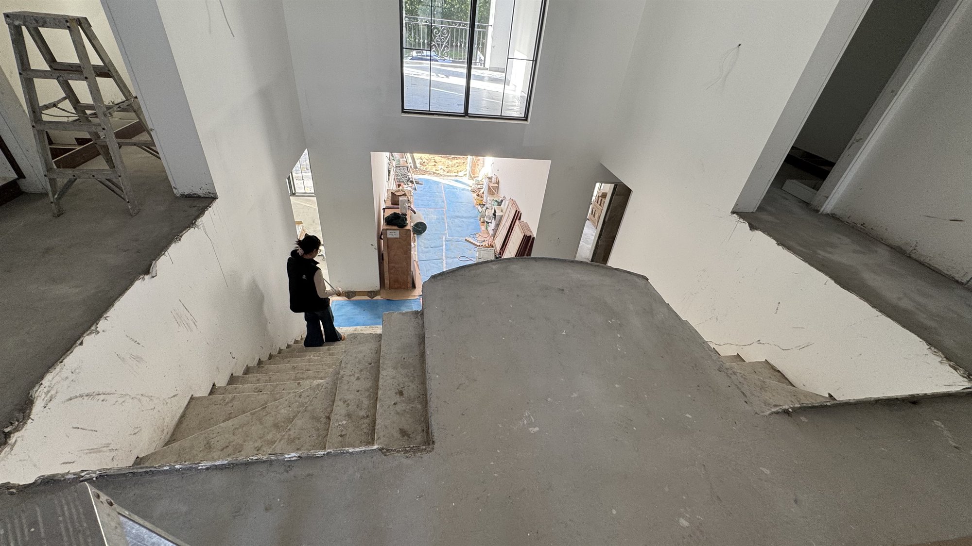 Unfinished multi-flight concrete stairwell seen from above in a Sydney home under construction