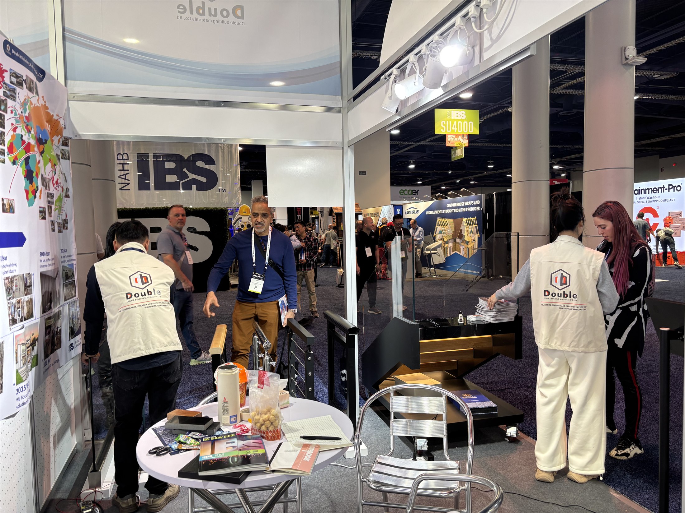 IBS hall signage above the Double Building booth with staff and visitors