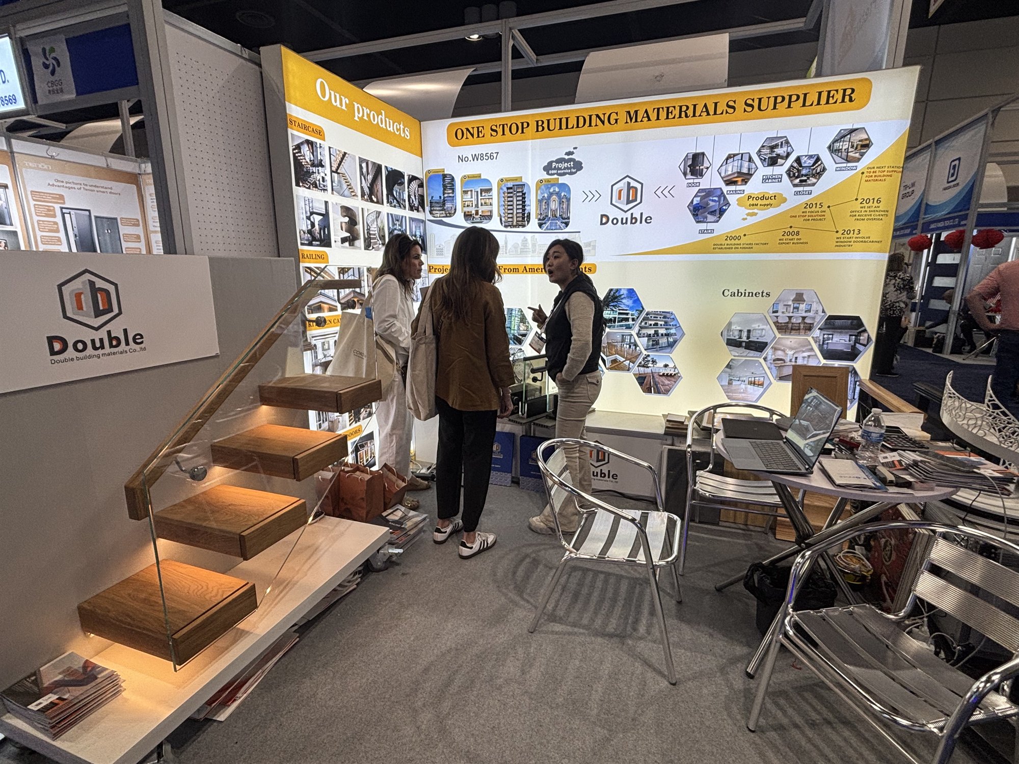 Visitors looking at the floating staircase sample at booth W8567