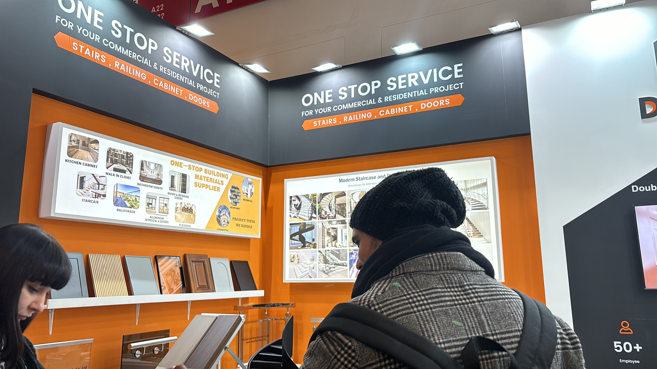Visitor looking at finish samples under the one-stop board at stand 443