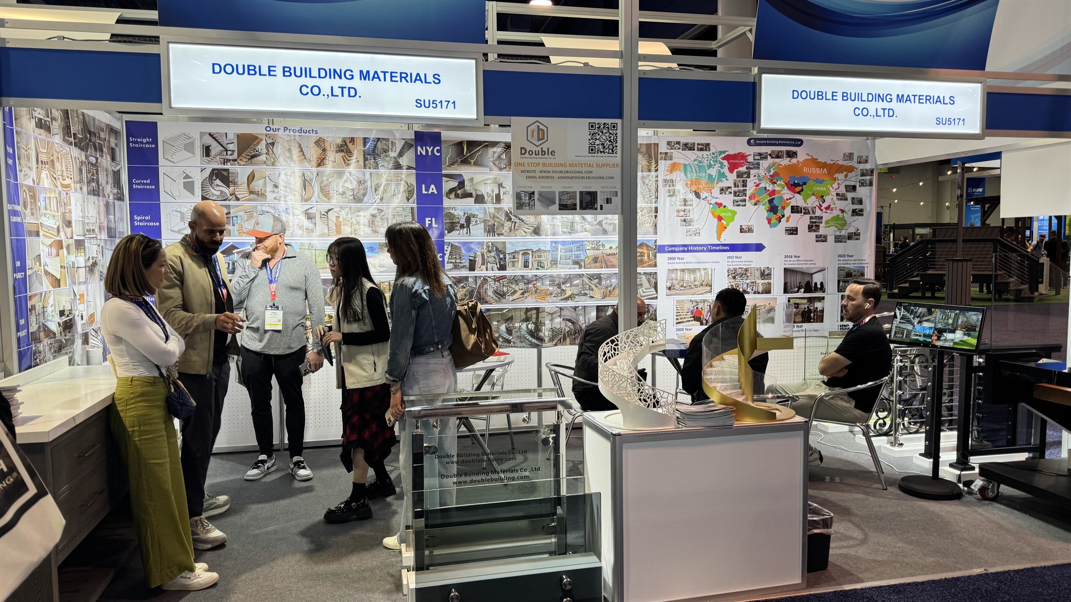 Visitors browsing catalogues at booth SU5171