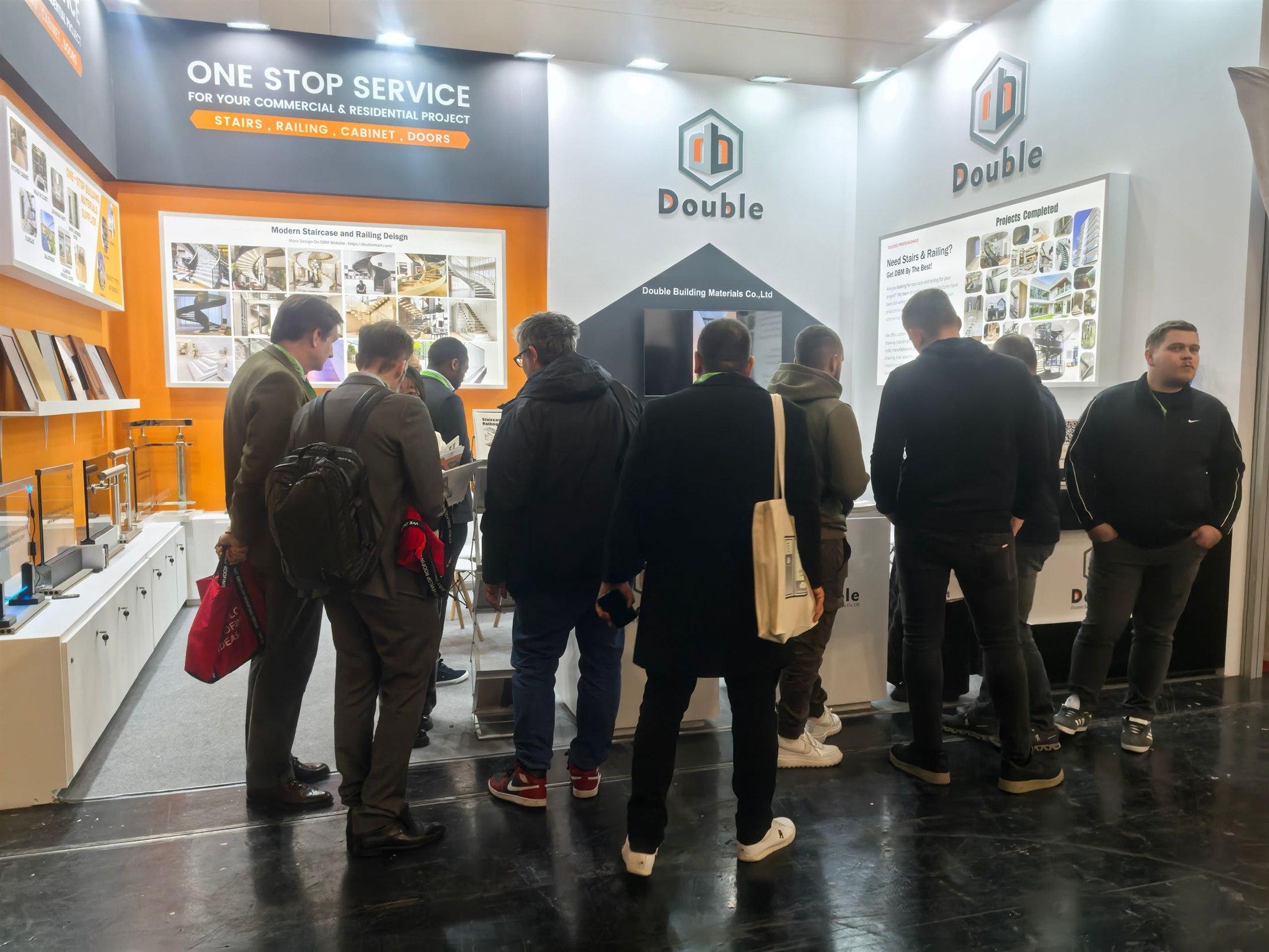 Visitors standing at the Double Building stand looking at staircase and railing project boards